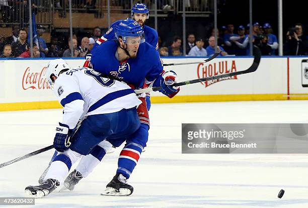 Anton Stralman of the Tampa Bay Lightning checks J.T. Miller of the New York Rangers in the second period of Game One of the Eastern Conference...