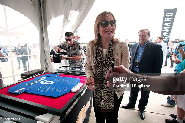 General Motors CEO Mary Barra signs a piece of Camaro memorabilia that will be auctioned before GM officially reveals the new 2016 Chevrolet Camaro...