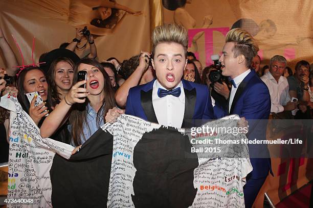 John Grimes and Edward Grimes of the band Jedward pose with fans during the Life Ball 2015 at City Hall on May 16, 2015 in Vienna, Austria.