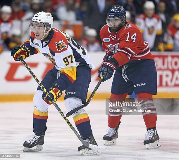 Connor McDavid of the Erie Otters is covered by Bradley Latour of the Oshawa Generals in Game Five of the OHL Robertson Cup Championship Final at...