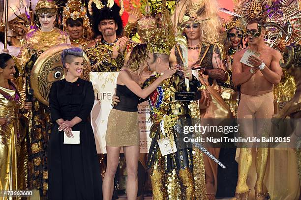 The winner of the award 'Life Ball Queen 2015' celebrates with Kelly Osbourne and Hana Jirickova during the Life Ball 2015 show at City Hall on May...