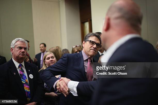 Former Texas Governor Rick Perry greets guests at the Republican Party of Iowa's Lincoln Dinner at the Iowa Events Center on May 16, 2015 in Des...