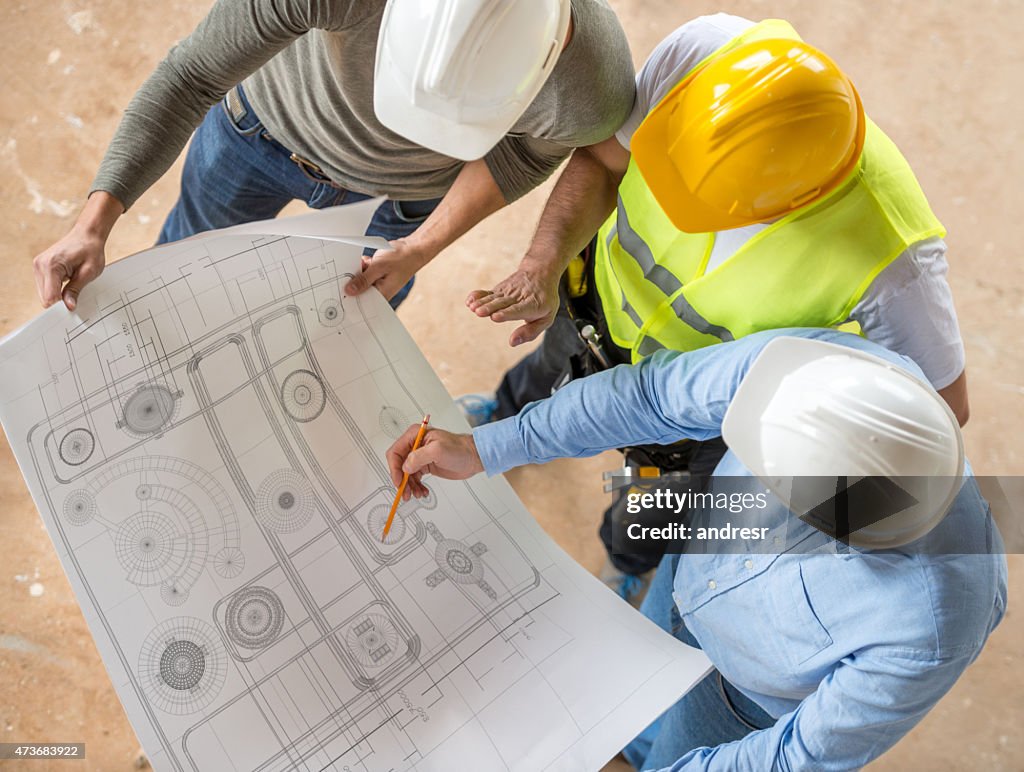 Civil engineers looking at blueprints