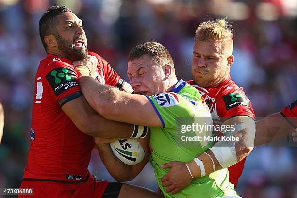 Benji Marshall and Jack de Belin of the Dragons tackle Shannon Boyd of the Raiders during the round 10 NRL match between the St George Illawarra...