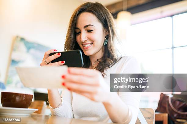 check remote deposit capture at cafe - cheque stock pictures, royalty-free photos & images