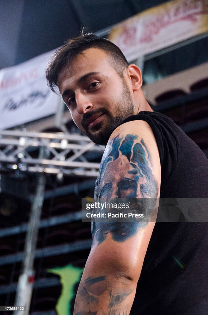 A man shows his tattoo on his shoulder.Greek Tattoo Artists...