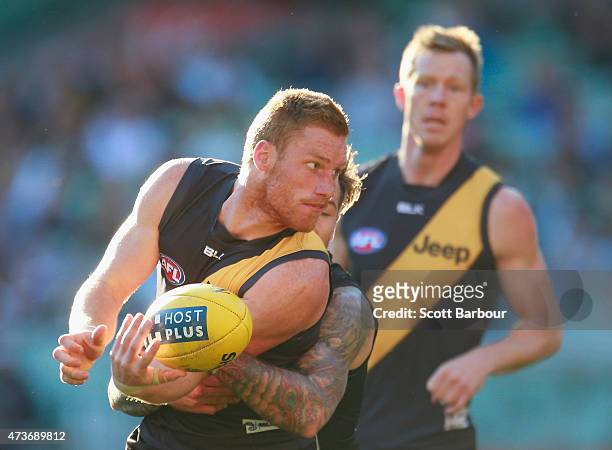 Nick Vlastuin of the Tigers is tackled by Jamie Elliott of the Magpies during the round seven AFL match between the Richmond Tigers and the...
