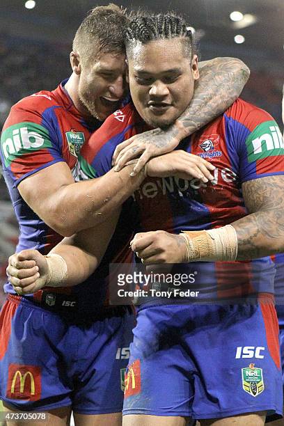 Joey Leilua of the Knights celebrates a try with team mate Tariq Sims during the round 10 NRL match between the Newcastle Knights and the Wests...