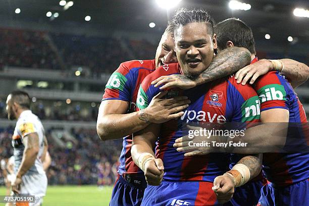 Joey Leilua of the Knights celebrates a try with team mate Tariq Sims during the round 10 NRL match between the Newcastle Knights and the Wests...