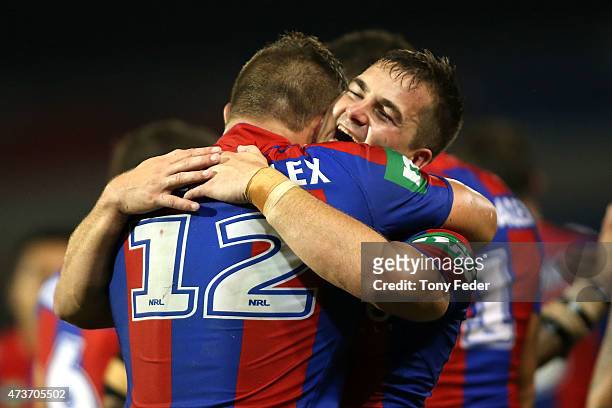 Chad Redman of the Knights celebrates a try with team mate Tariq Sims during the round 10 NRL match between the Newcastle Knights and the Wests...