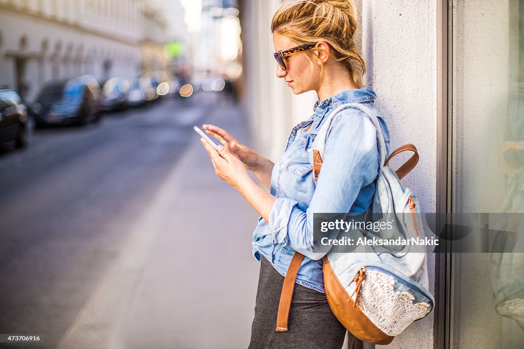 Stylish woman using a smartphone outdoors