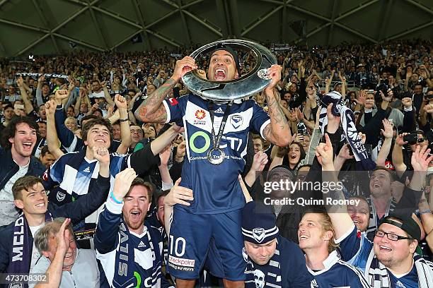 Archie Thompson of the Victory shows the trophy to the crowd after the Victory won the 2015 A-League Grand Final match between the Melbourne Victory...