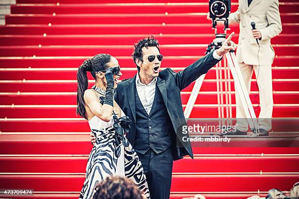 celebrity couple on red carpet in cannes - fame stockfoto's en -beelden