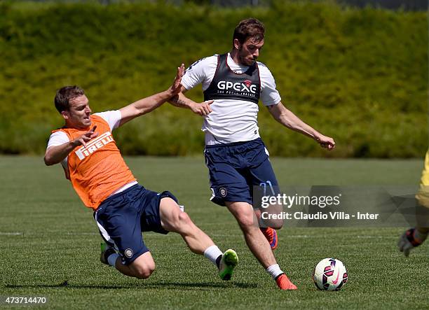 Hugo Campagnaro and Davide Santon compete for the ball during FC Internazionale training session at the club's training ground at Appiano Gentile on...