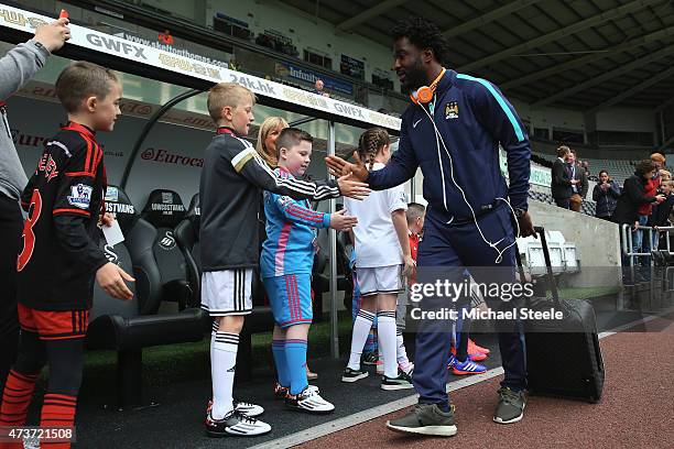 Wilfried Bony of Manchester City greets young Swansea mascots as he arrives at the stadium during the Barclays Premier League match between Swansea...