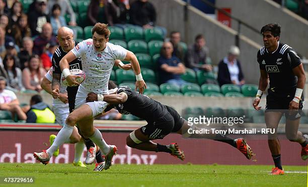 Alex Gray of England is tackled by Lote Raikabula of New Zealand during the Cup quarter final match match between New Zealand and England on Day Two...