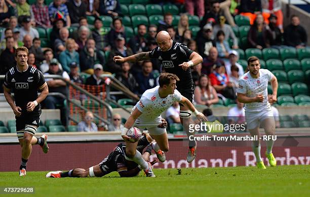 Alex Gray of England is tackled by Lote Raikabula of New Zealand during the Cup quarter final match match between New Zealand and England on Day Two...
