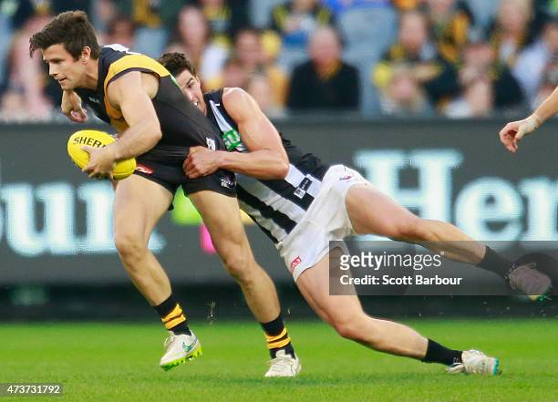 Trent Cotchin of the Tigers is tackled during the round seven AFL match between the Richmond Tigers and the Collingwood Magpies at the Melbourne...