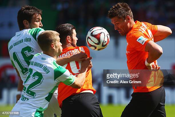 Goran Sukalo and Johannes Wurtz of Greuther Fuerth are challenged by Marcel Heller and Ronny Koenig of Darmstadt during the Second Bundesliga match...