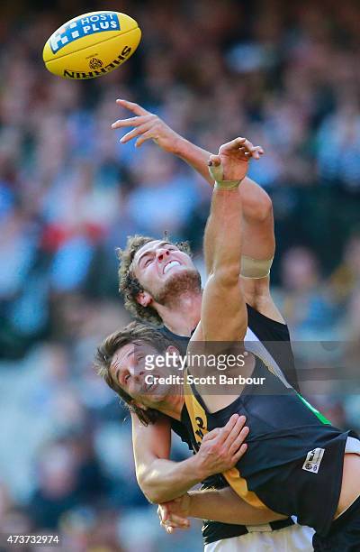Ivan Maric of the Tigers and Jarrod Witts of the Magpies compete for the ball during the round seven AFL match between the Richmond Tigers and the...