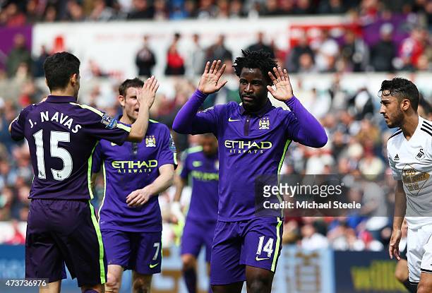 Wilfred Bony of Manchester City celebrates with teammate Jesus Navas of Manchester City after scoring his team's fourth goal during the Barclays...