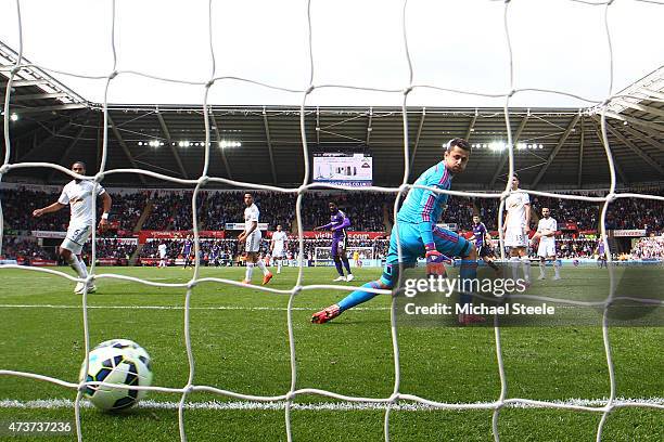 Wilfred Bony of Manchester City scores his team's fourth goal past goalkeeper Lukasz Fabianski of Swansea City during the Barclays Premier League...