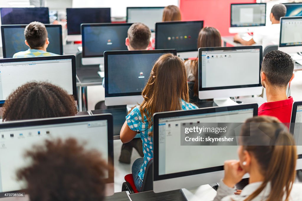 Rear view of group of people in a computer seminar.