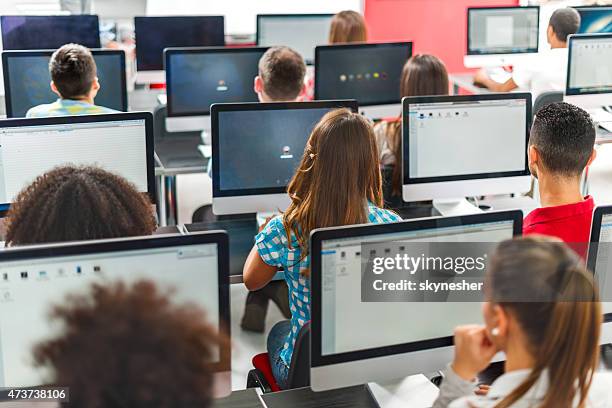 rear view of group of people in a computer seminar. - computer lab stock pictures, royalty-free photos & images