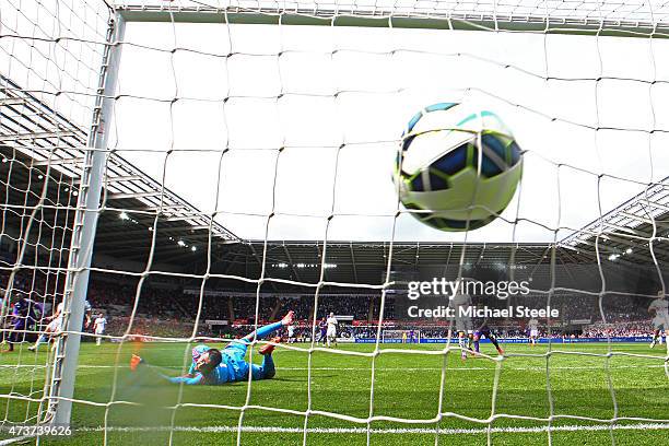 Yaya Toure of Manchester City scores is team's third goal past the outstretched Lukasz Fabianski of Swansea City during the Barclays Premier League...