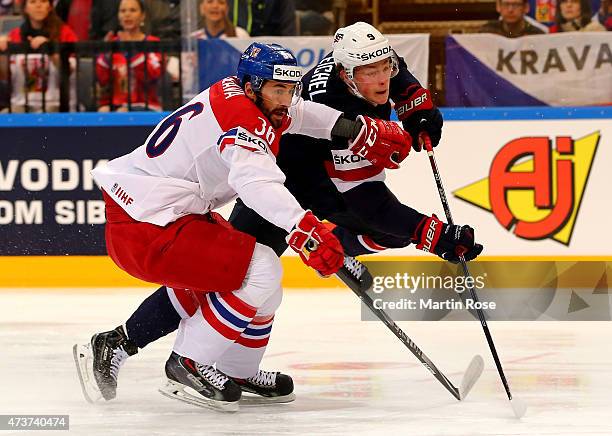 Petr Caslava of Czech Republic and JAck Eichel of USA battle for the puck during the IIHF World Championship bronze medal match between Crech...