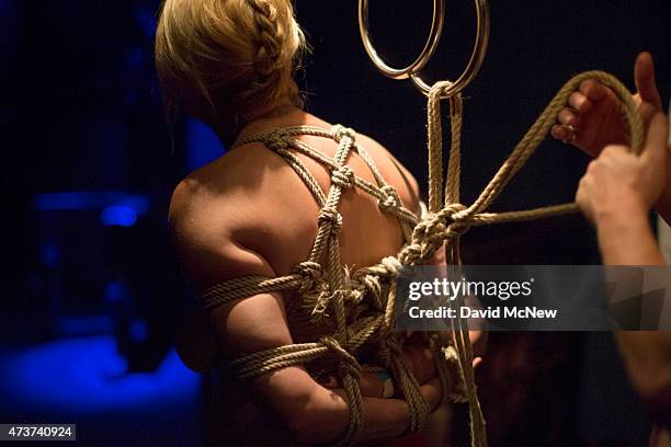 Lady Dalbin is tied up by Michael Lumos for her enjoyment at a dungeon party during the domination convention, DomCon LA, on May 16, 2015 in Los...