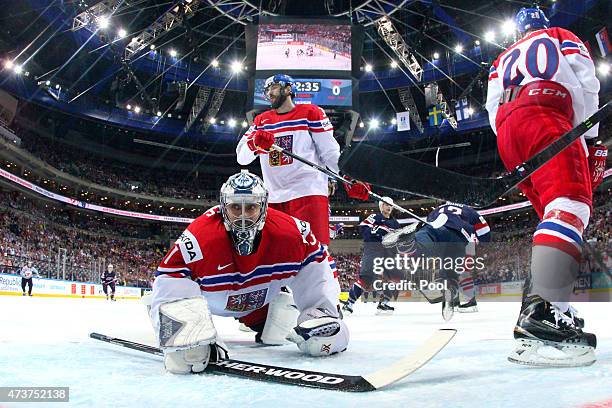 Dejected goaltender Ondrej Pavelec of Czech Republic looks on Nick Bonino of USA celebrates scoring the opening goal during the 2015 IIHF Ice Hockey...