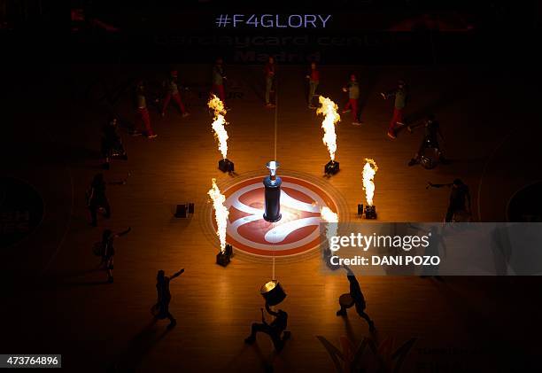 Dancers and musicians perform around the Euroleague trophy before the Euroleague Final Four basketball match final between Real Madrid and Olympiacos...