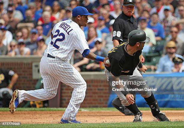 Addison Russell of the Chicago Cubs tags out Neil Walker of the Pittsburgh Pirates on a run-down in the 5th inning at Wrigley Field on May 17, 2015...