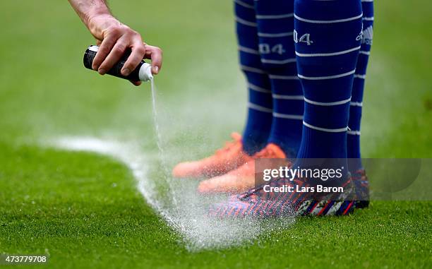 The referee uses vanashing spray for a free kick during the Bundesliga match between FC Schalke 04 and SC Paderborn at Veltins Arena on May 16, 2015...