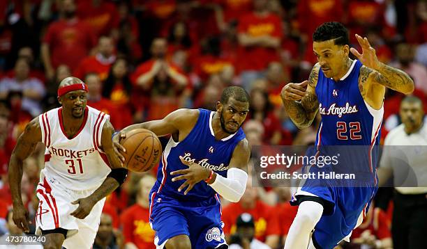 Chris Paul of the Los Angeles Clippers controls the ball as teammate Matt Barnes looks on in the third quarter against the Houston Rockets during...