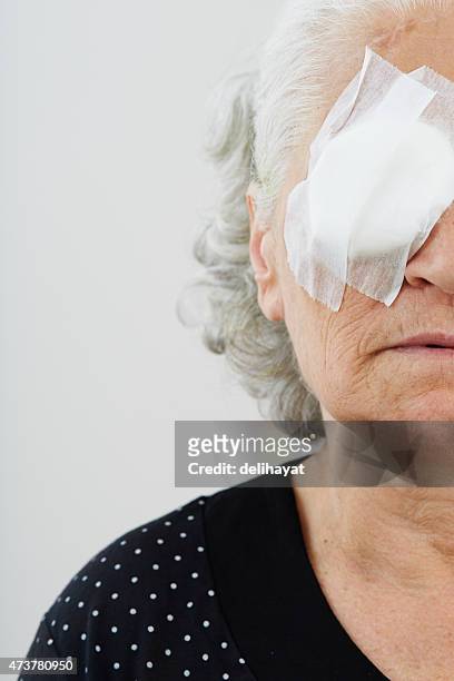 elder female with eye patch - medical eye patch stockfoto's en -beelden