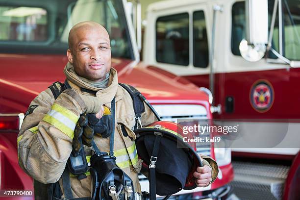 african american fireman at fire station - pics of firefighters stock pictures, royalty-free photos & images
