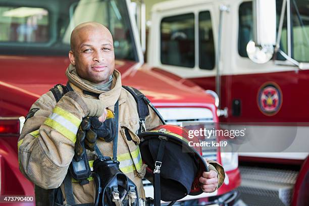 african american fireman at fire station - fireman stock pictures, royalty-free photos & images