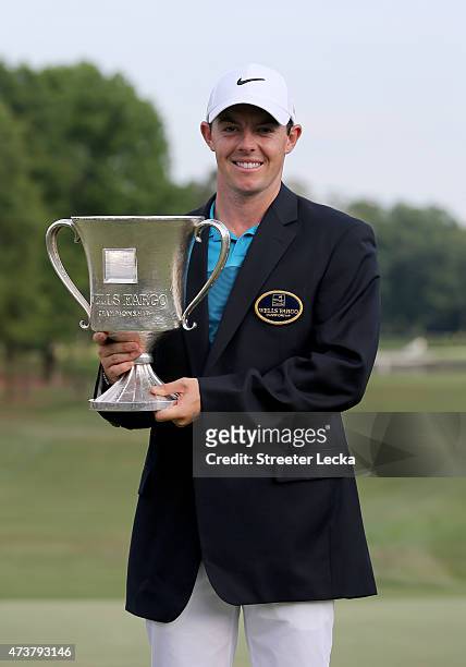 Rory McIlroy of Northern Ireland poses with the trophy after his win on the 18th hole during the final round at the Wells Fargo Championship at Quail...