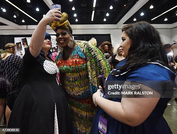 Drag Queen Latice Royale poses with fans during the inaugural RuPauls DragCon at the Los Angeles Convention Center, California on May 17, 2015. The...