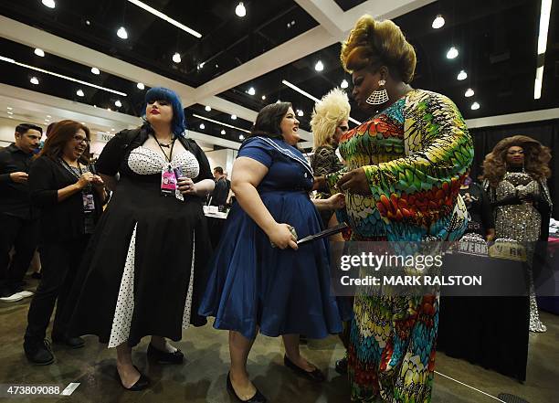 Drag Queen Latice Royale poses with fans during the inaugural RuPauls DragCon at the Los Angeles Convention Center, California on May 17, 2015. The...