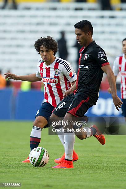 Carlos Valenzuela of Atlas fights for the ball with Giovani Hernandez of Chivas during a quarterfinal second leg match between Atlas and Chivas as...