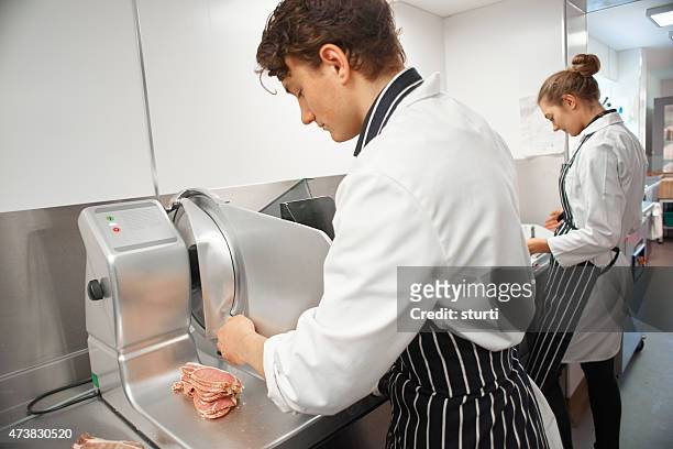 slicing bacon in a butcher's shop - bacon strip stock pictures, royalty-free photos & images