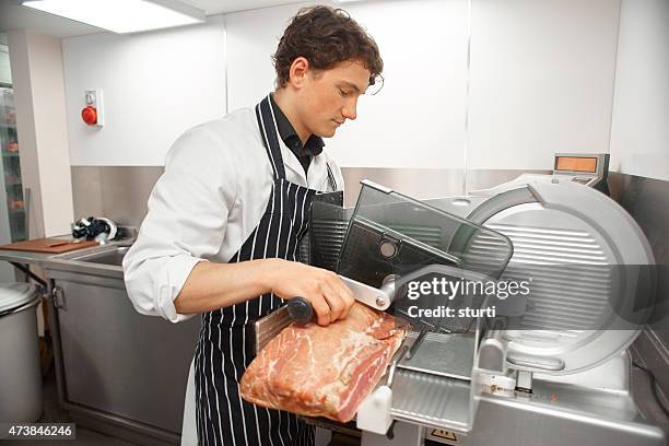 slicing bacon in a butcher's shop - butcher shop stock pictures, royalty-free photos & images