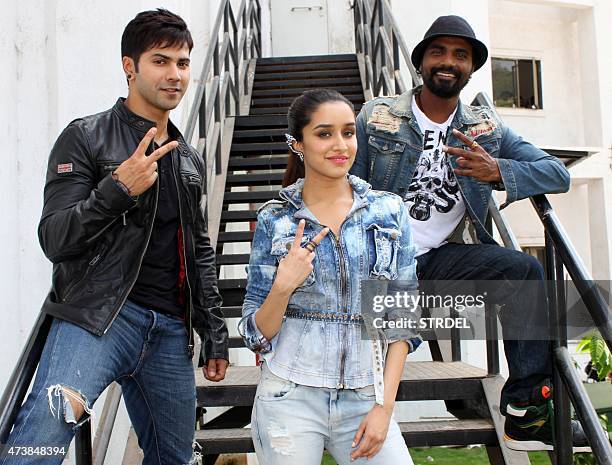 Indian Bollywood actress Shraddha Kapoor poses with actors Varun Dhawan and director Remo DSouza during a promotional event for the forthcoming Hindi...