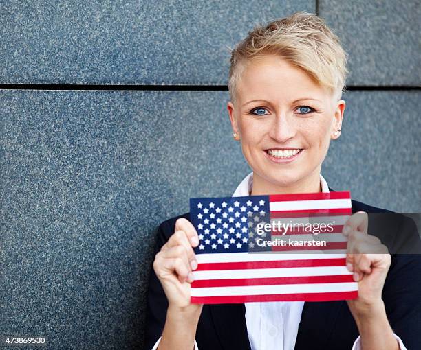 Attractive woman holding flag of the United States of America