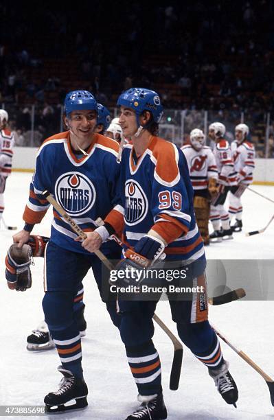 Jari Kurri and Wayne Gretzky of the Edmonton Oilers talk on the ice before an NHL game against the New Jersey Devils on March 1, 1983 at the Brendan...