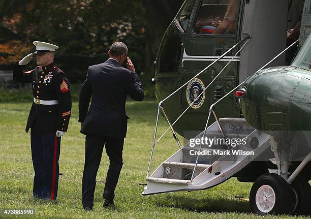 President Barack Obama salutes as he boards Marine One while departing the White House, May 18, 2015 in Washington, DC. President Obama is traveling...