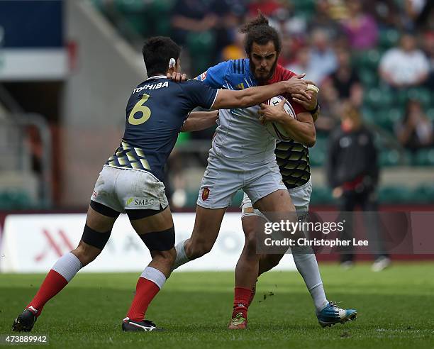 Jonathan Laugel of France is stopped by Lomano Lemeki and Yusaku Kuwazuru of Japan during the Shield Final match between Japan and France in the...